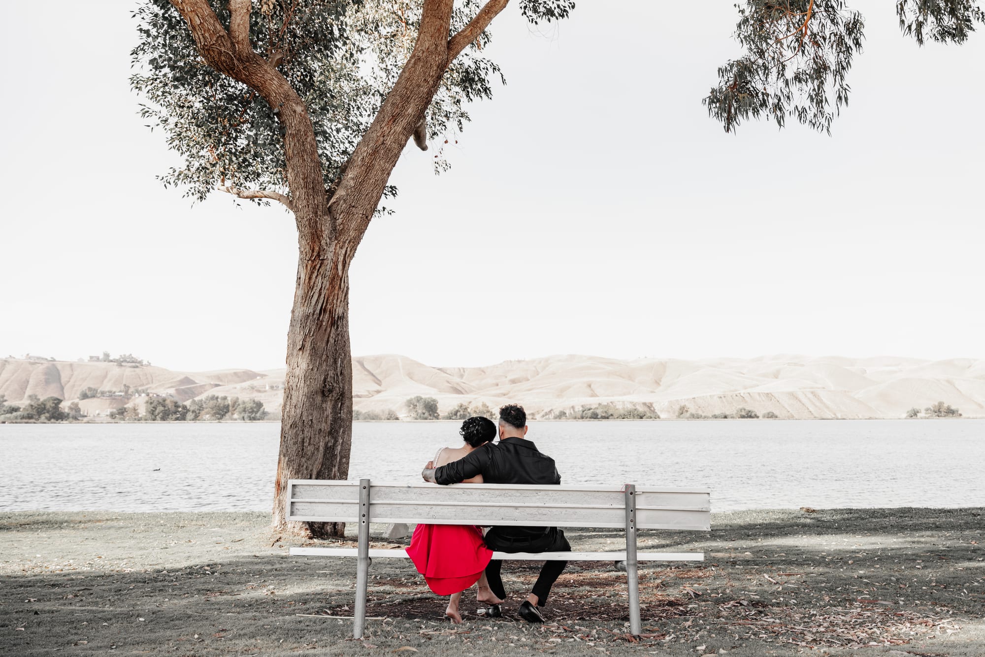 Quiet wedding portrait on a lakeside bench