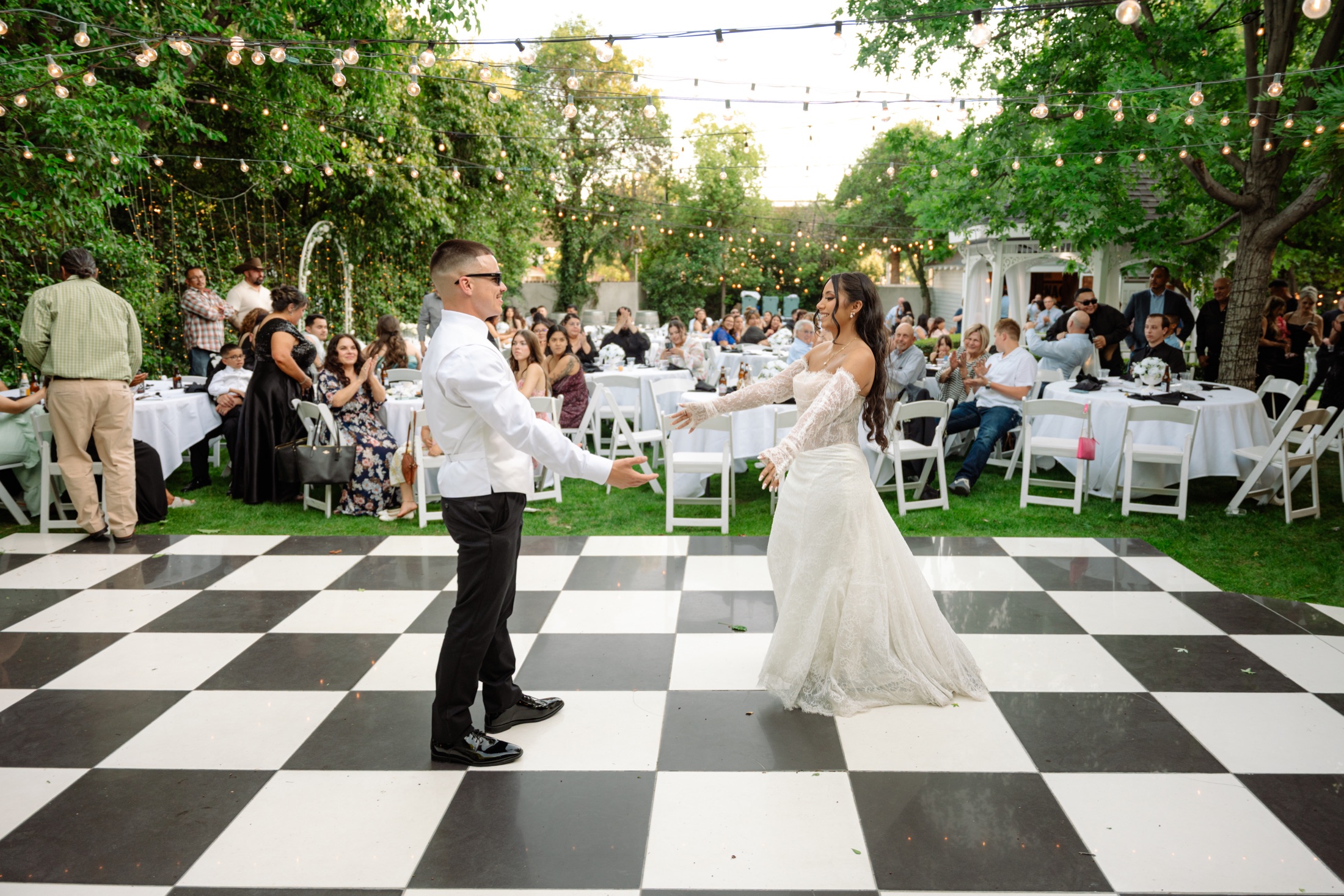 Bride and groom beginning their first dance at an outdoor wedding reception