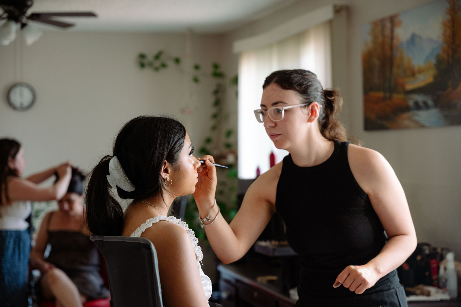 Bride getting makeup touched up before her wedding